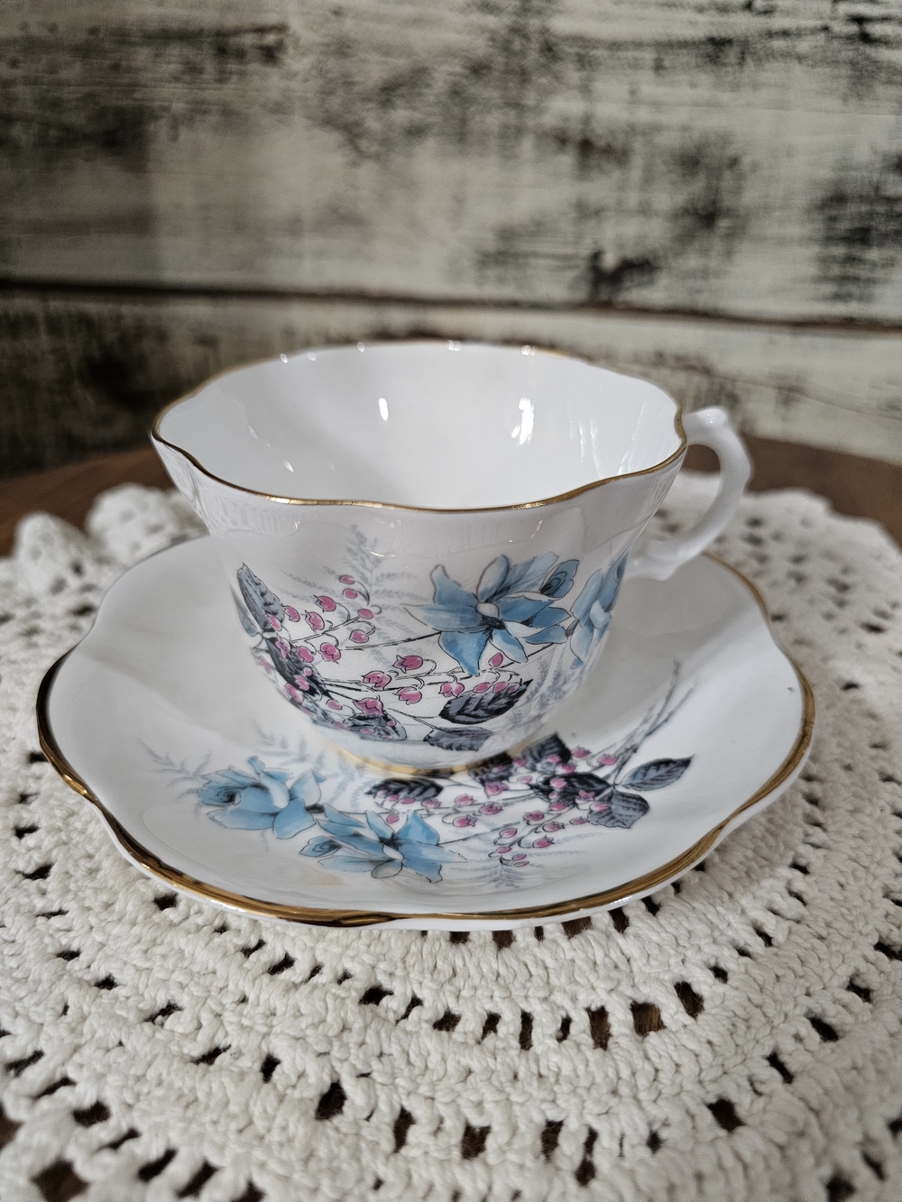 Elegant Blue Floral Porcelain Teacup and Saucer with Gold Trim